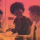 Teacher sitting at a table with two students